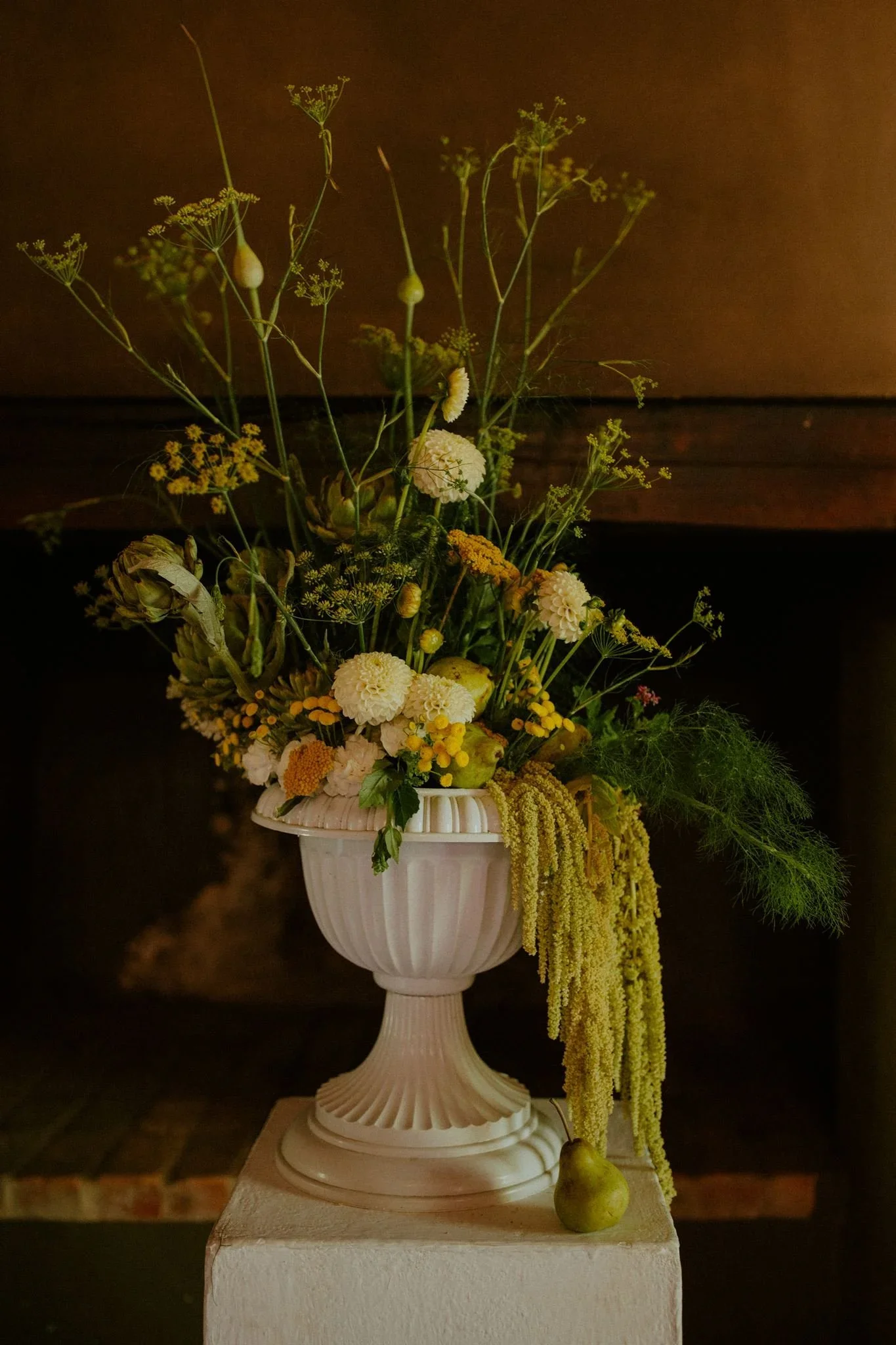 Reception table styled with green and yellow floral arrangements, candles and layered décor at Langkloof Roses.