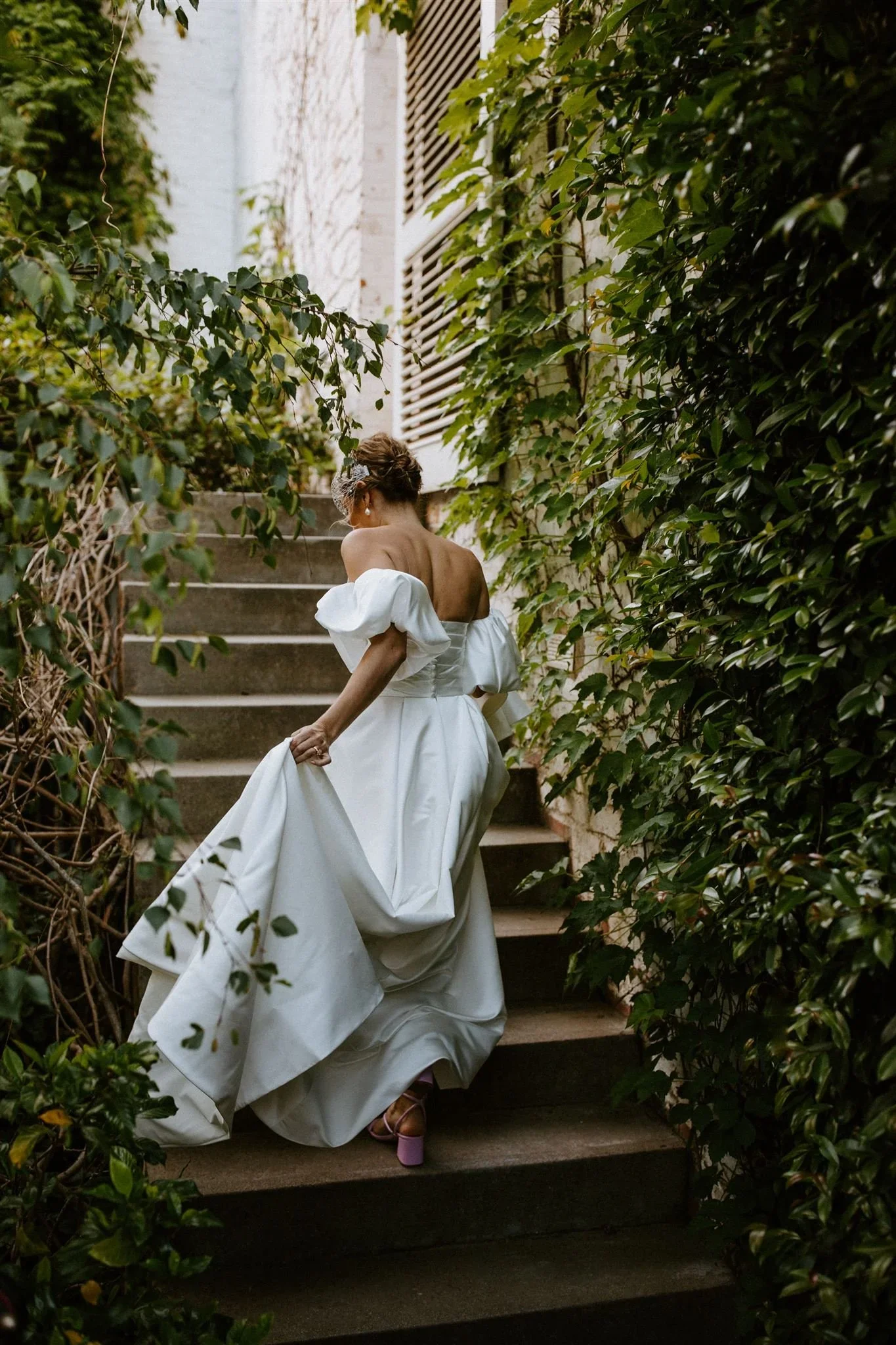 Bride walking up the stairs during cocktail hour for a quiet moment away from the celebration at Johannesdal