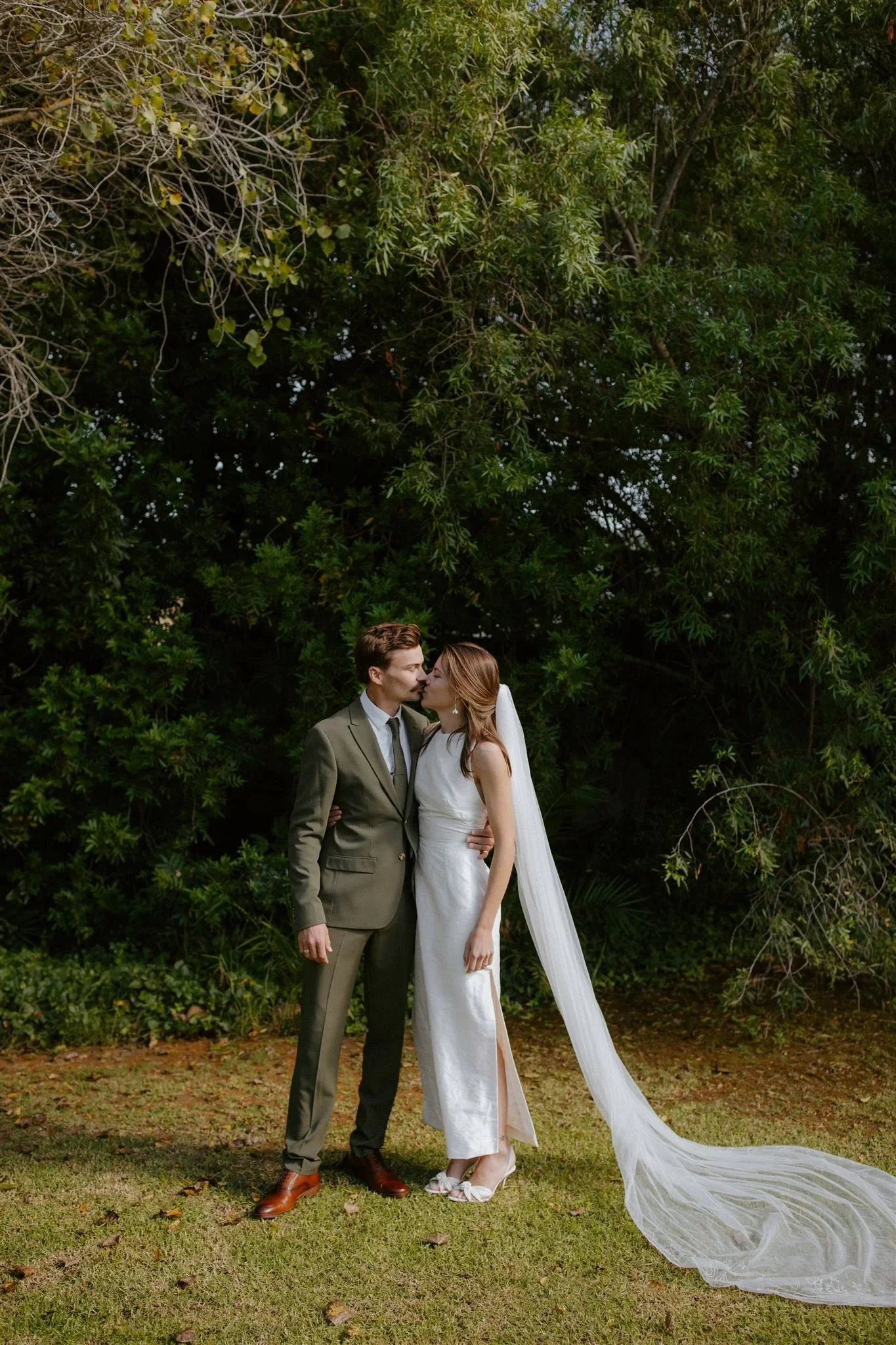 Bride and groom sharing a quiet moment in the garden after their first look in Stanford before their wedding ceremony.