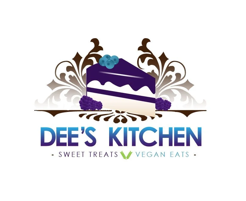 Logo for Dee's Kitchen featuring a purple and white cake with blueberries and blackberries, decorative foliage, and text reading 'Dee's Kitchen, Sweet Treats, Vegan Eats'.