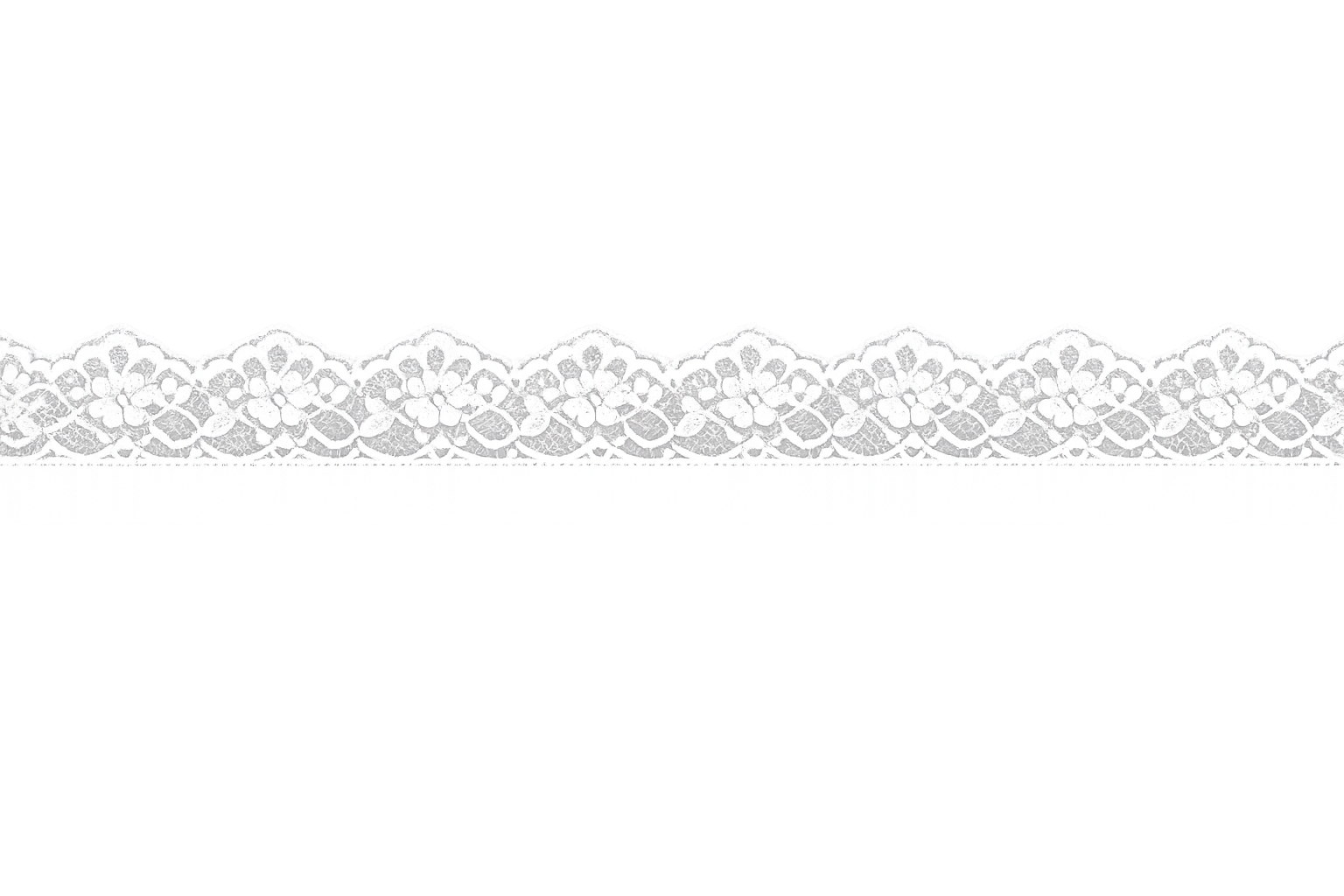 Close-up of white lace with floral pattern on black background.