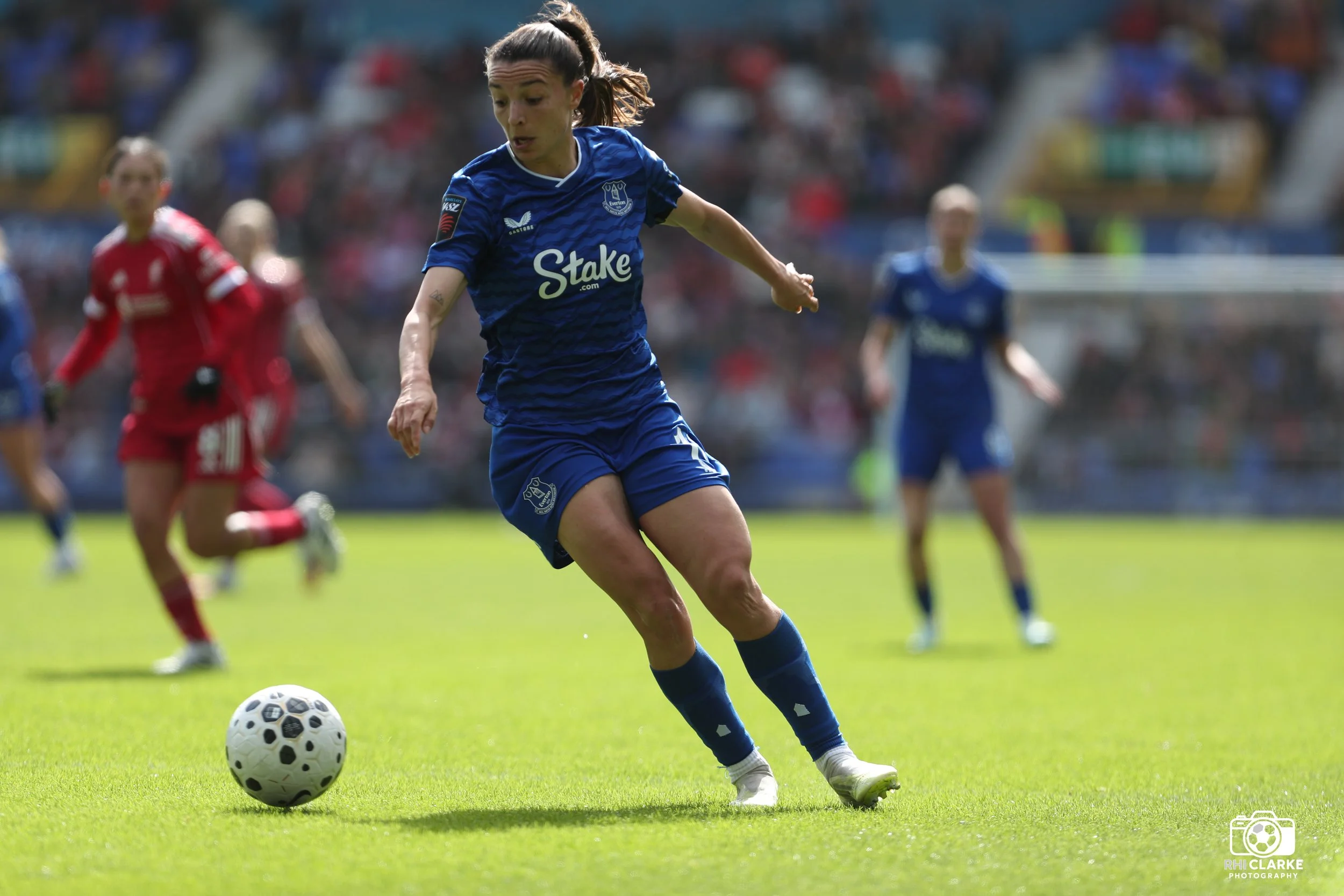 Barry Town United fBarry Town United footballer celebrating with arms outstretched after scoring, wearing a yellow home kit withootballer celebrating with arms outstretched after scoring, wearing a yellow home kit with RIM MOTORS sponsor on the chest