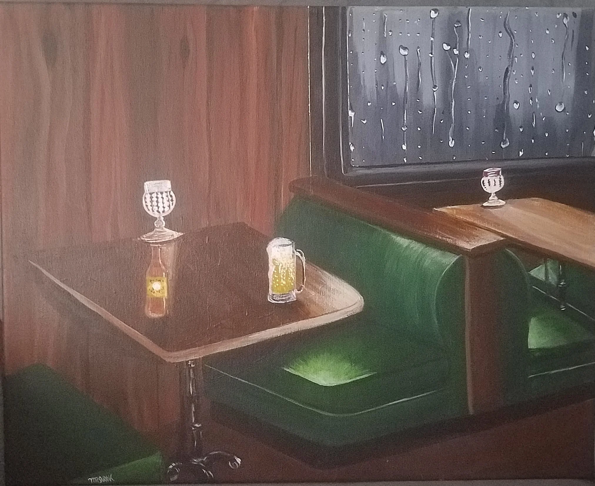 A view of a wooden billiards table with green felt, two glasses of beer and two bottles of beer on top, and a black wooden wall with a window and rain droplets outside.