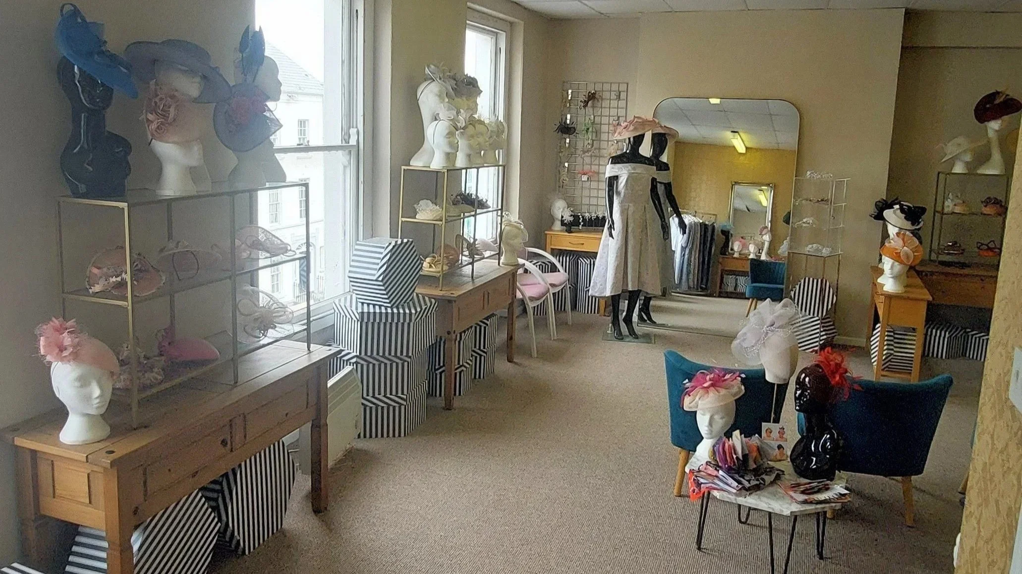 Display of stylish hats in the showroom at John Paul Millinery