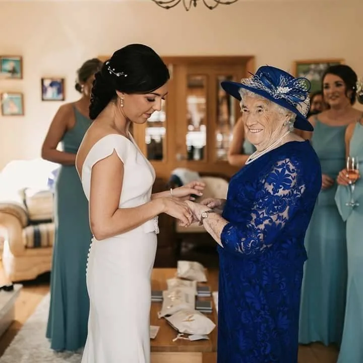 A Bride with her grandmother on her Wedding day. Her gran is in a John Paul Millinery navy hat.