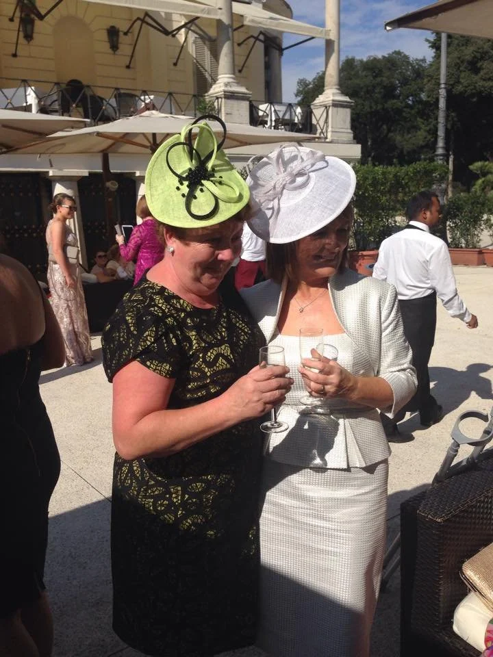 Italian Wedding - two Clients wearing John Paul Millinery at a Wedding in Italy