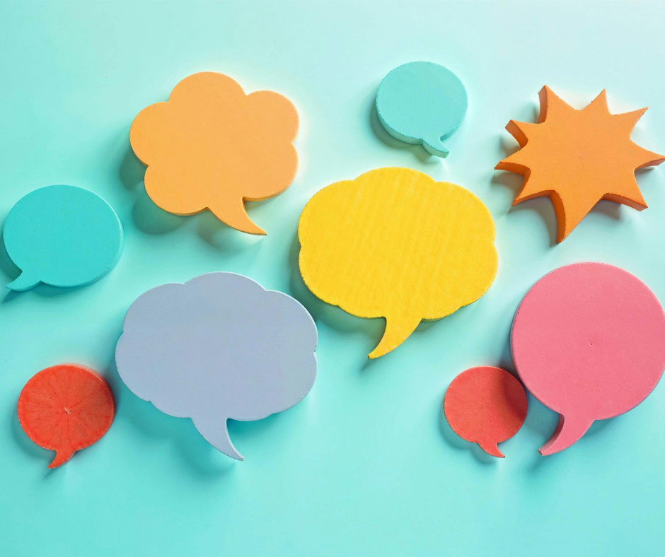 Colorful paper speech bubbles in various shapes and sizes on a blue background.
