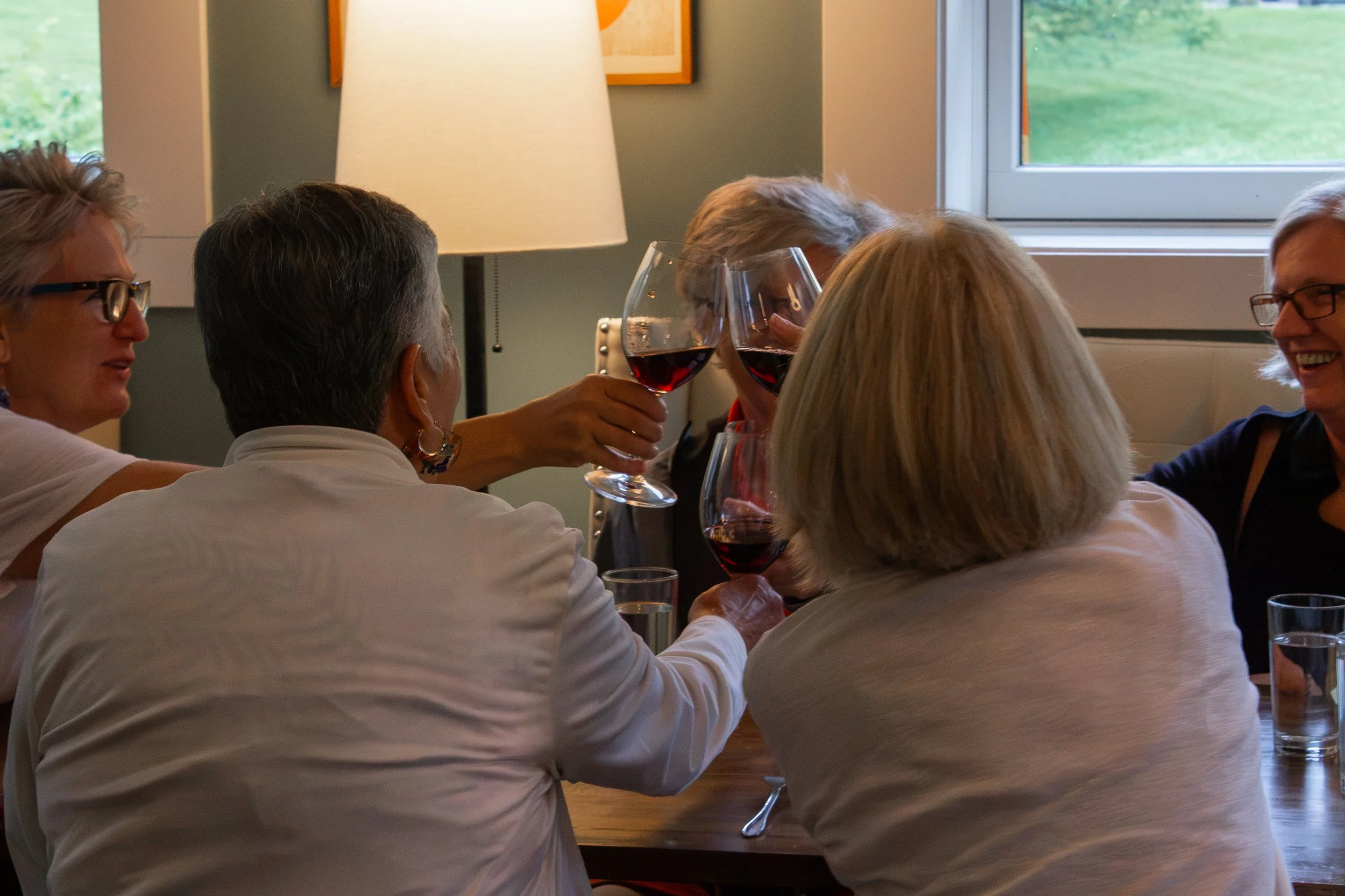 Guests toasting wine glasses.