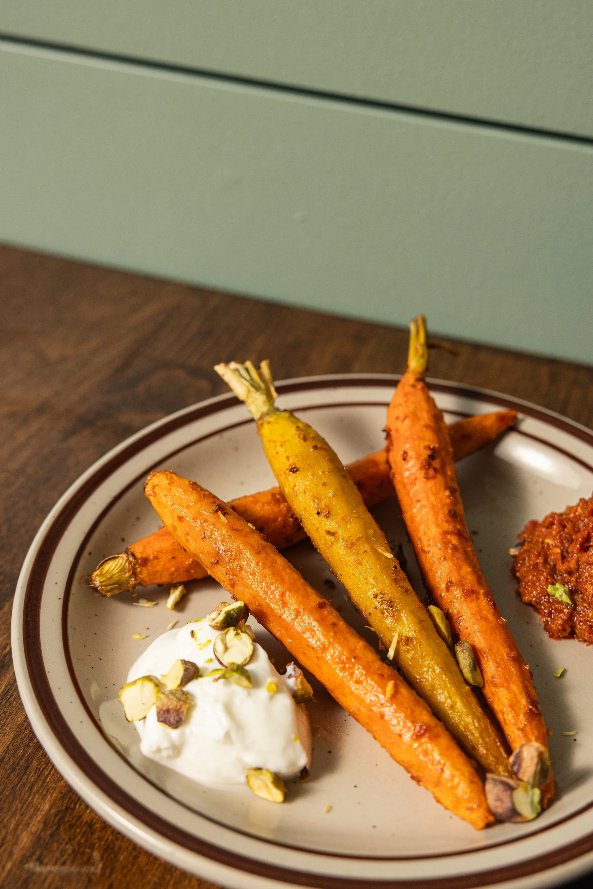 HARISSA ROASTED CARROTS
Roasted carrots, harissa, yogurt, pistachios and herbs (gf, v, tree nuts) · Morocco