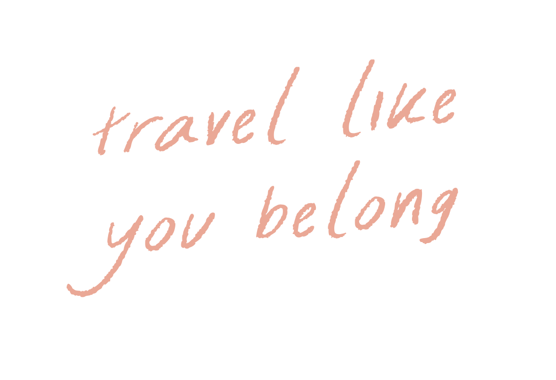 Inspirational quote reading 'Travel like you belong' in cursive red font on a black background.