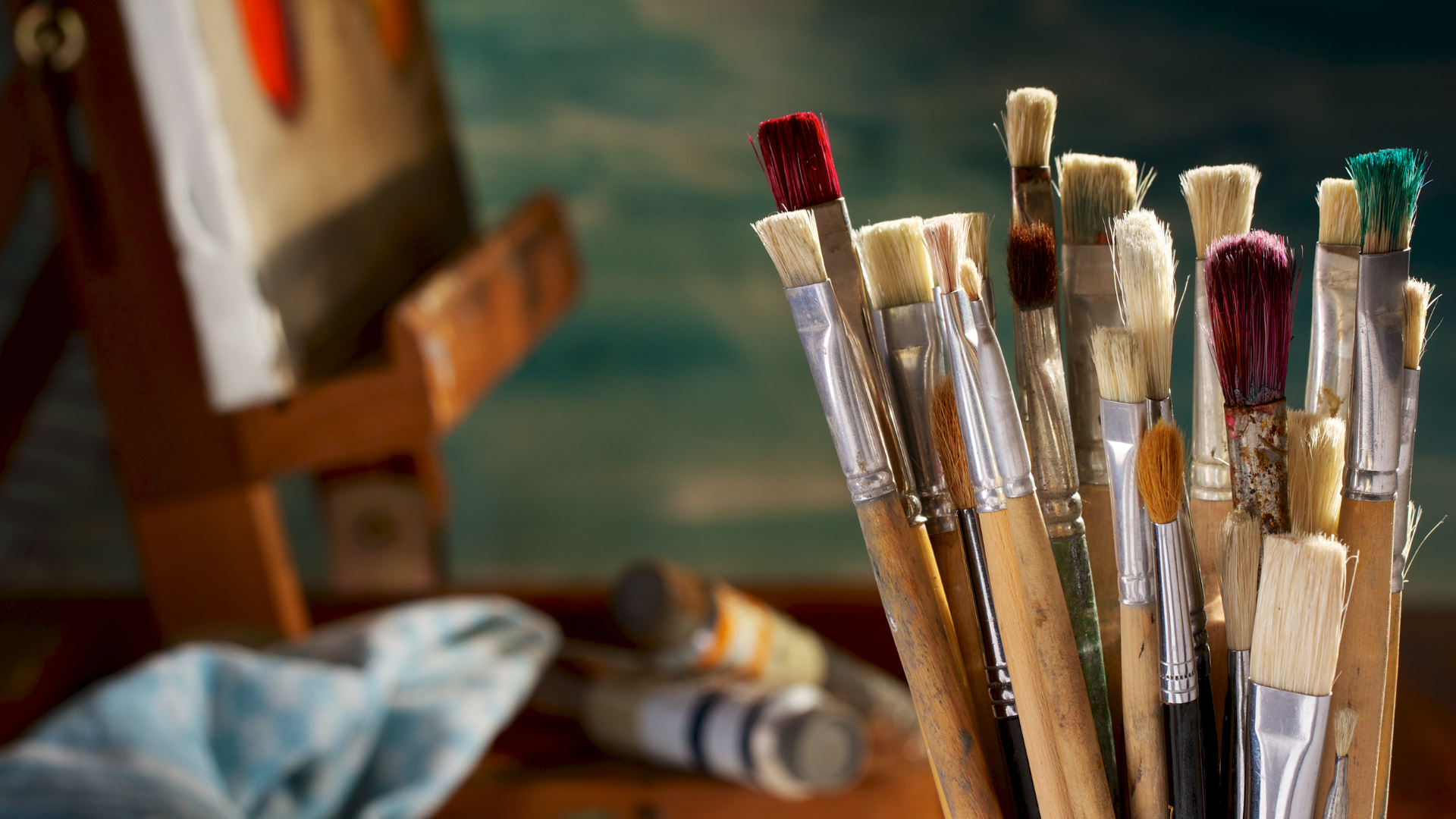 paintbrushes and easel in the background