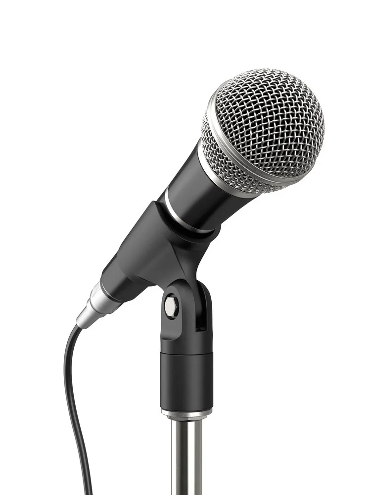 Close-up of a standard handheld microphone on a stand with a white background.