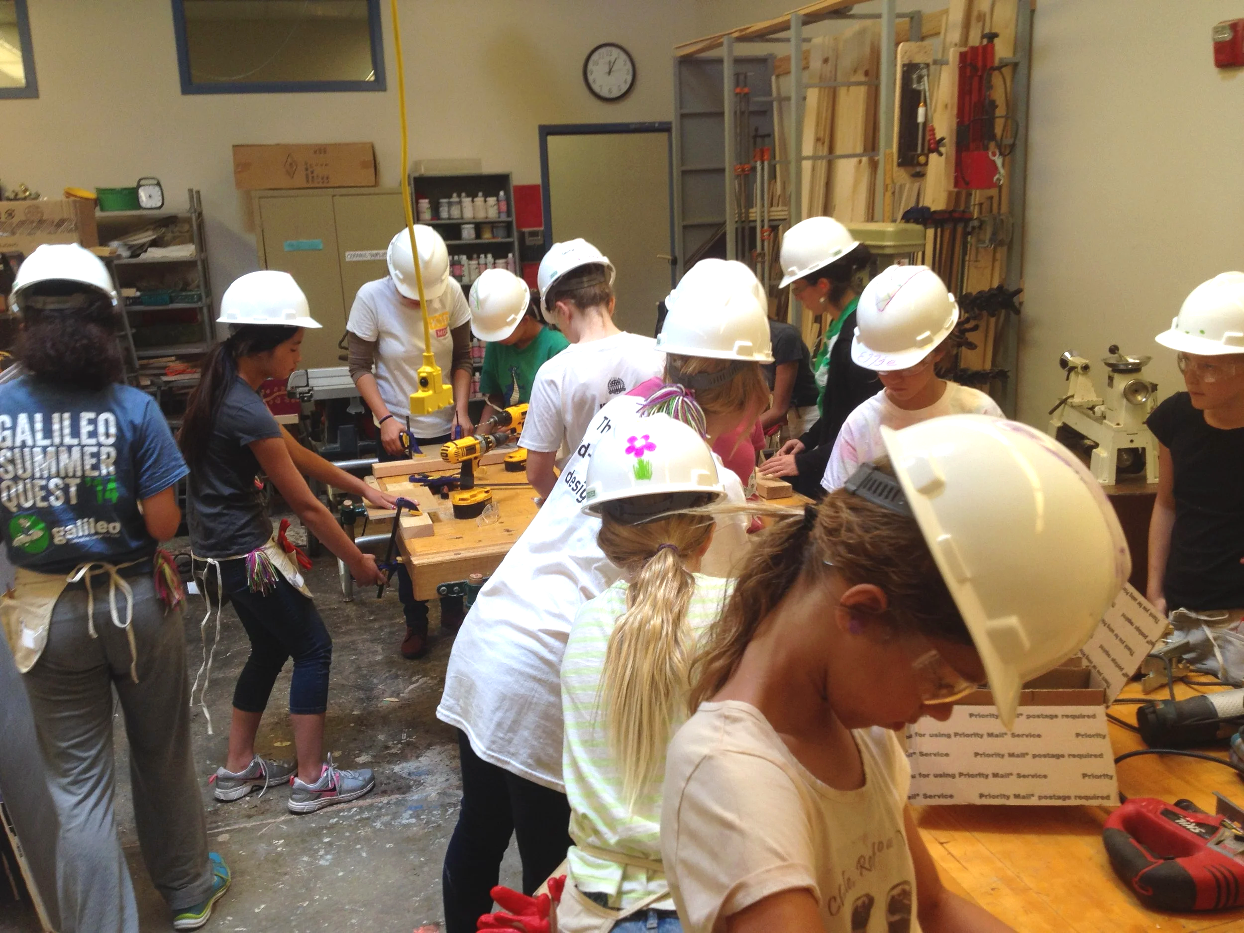 KIDmobsters, wearing hard hats and safety glasses, are hard at work in the woodshop!
