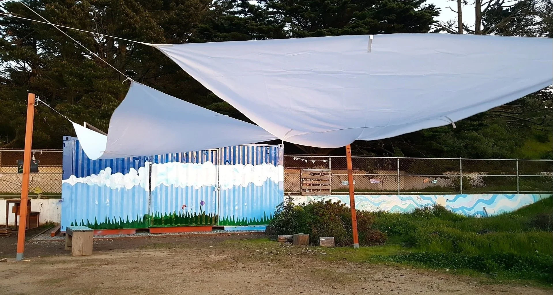 A multi-phased project, LMNOP later painted a mural of a sky and clouds on the shipping container. A shade structure is added.