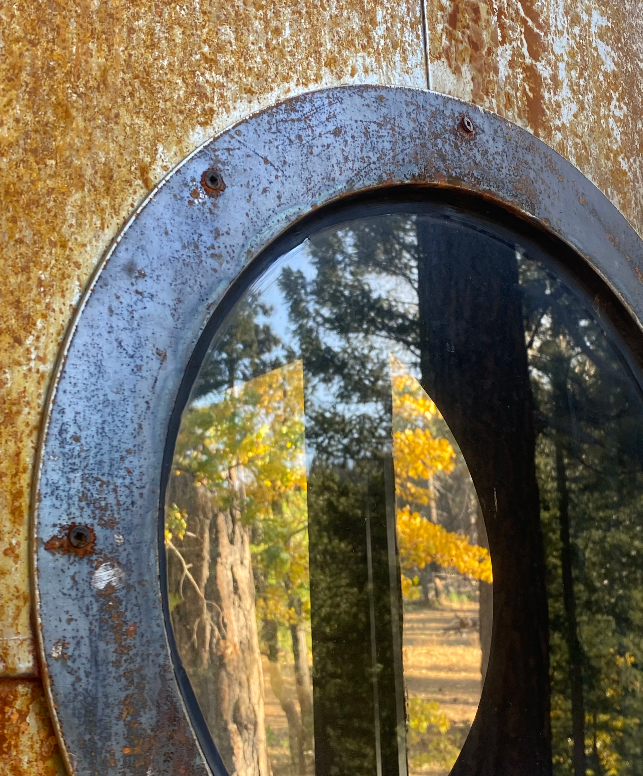 Close-up of one of the two porthole windows, offering a playful peek outdoors.