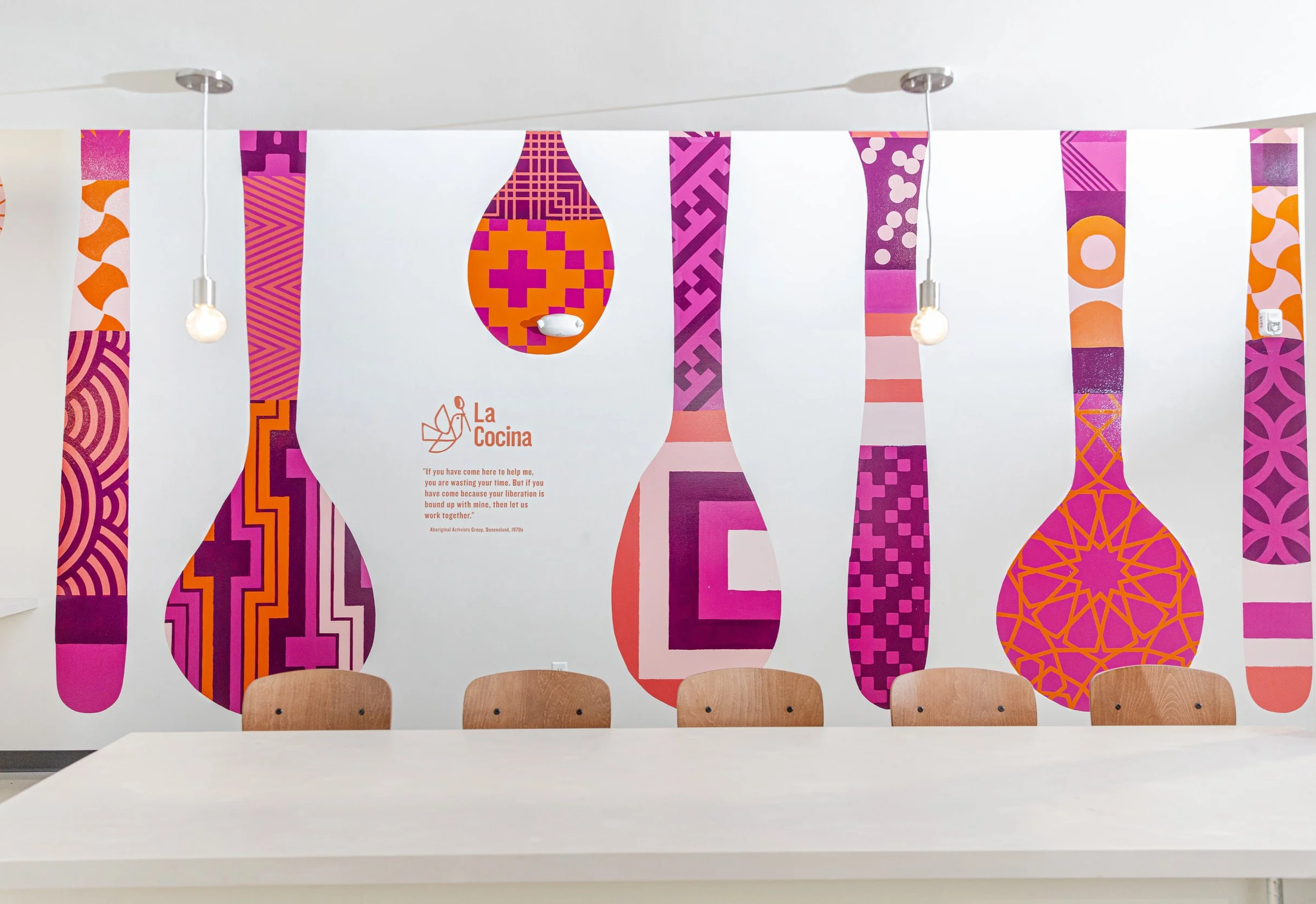 A custom mural of kitchen utensils, composed from various patterns, runs along one of the Marketplace's walls.