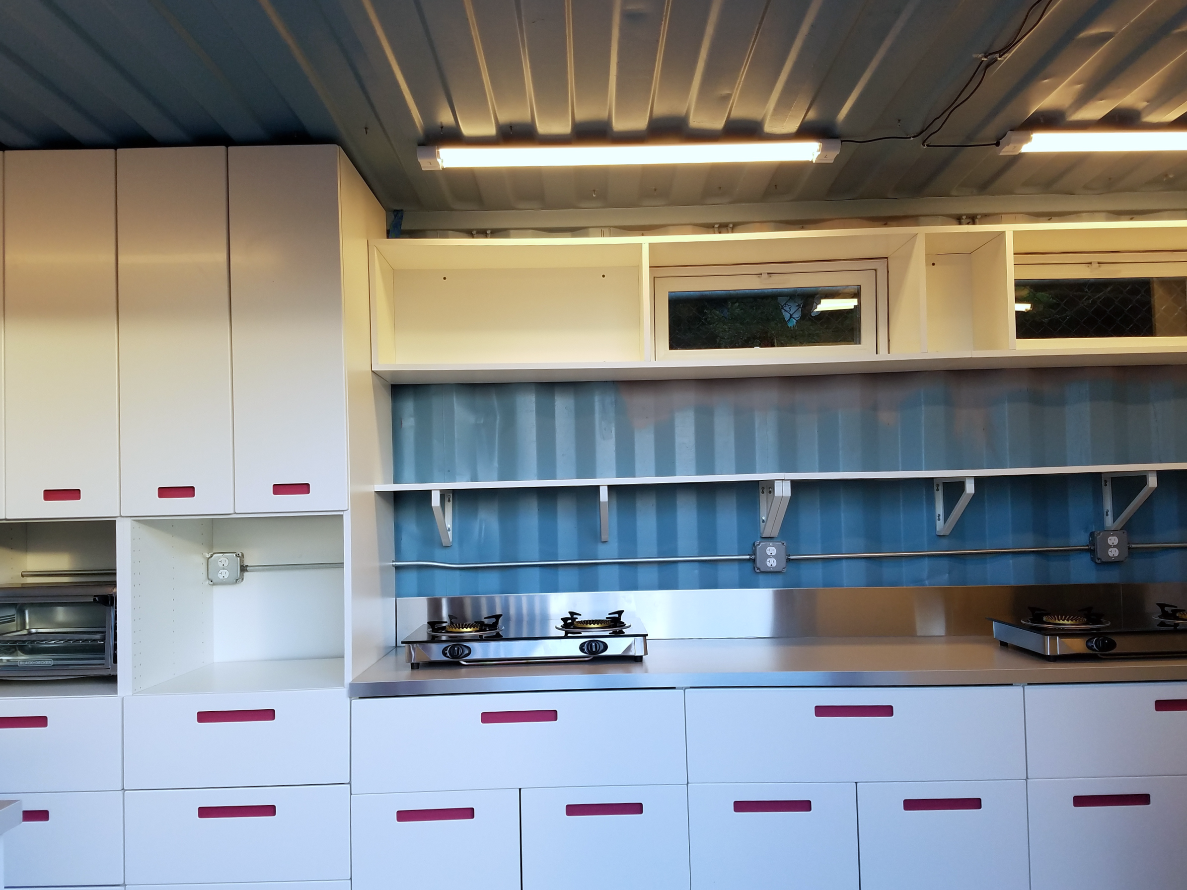 Inside the storage container, a sleek and simply furnished kitchen with tons of storage.