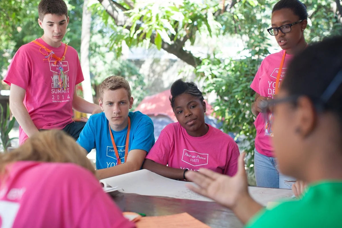 A group of KIDmob participants listen intentently.