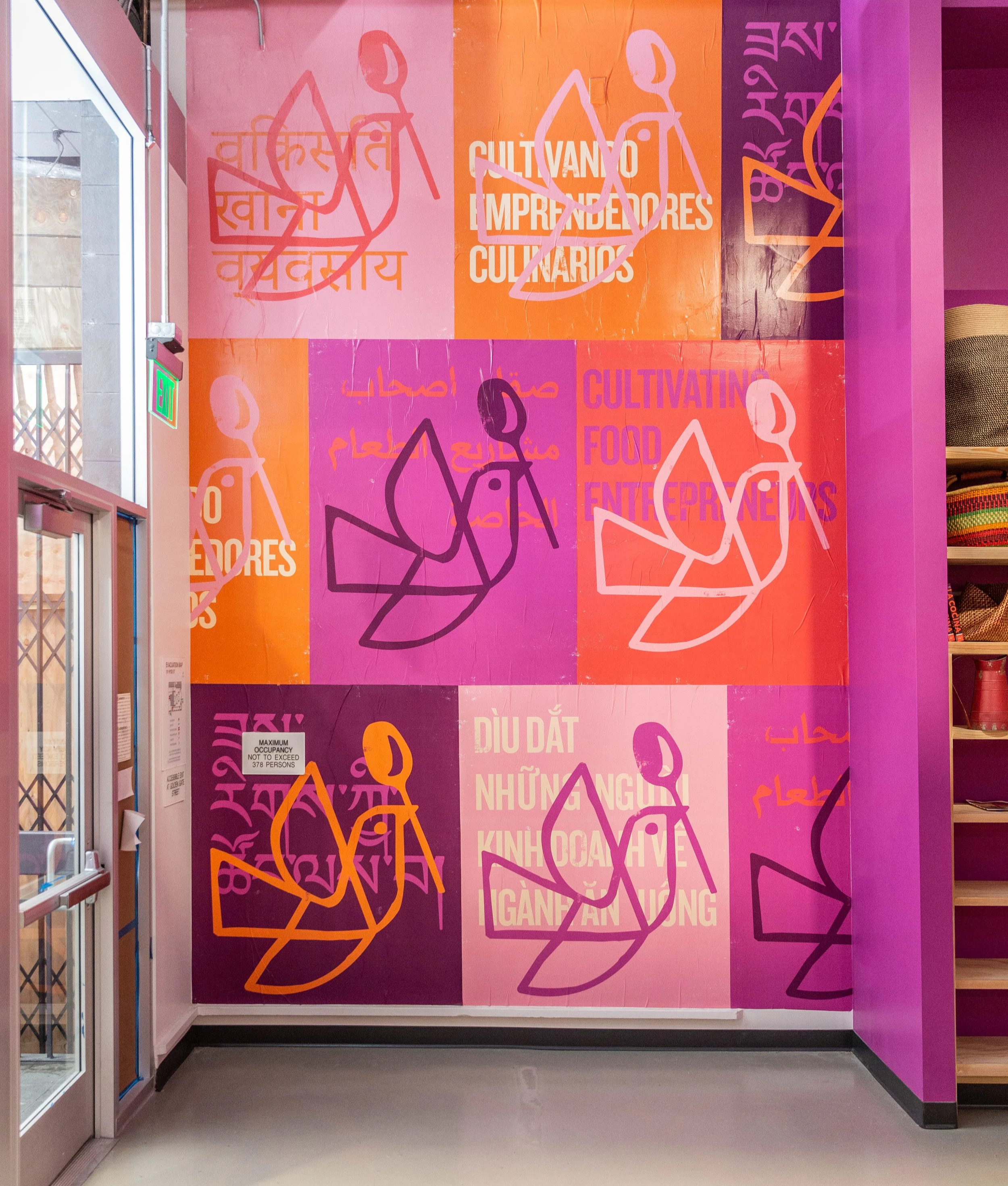 Front entrance with a collage of La Cocina's logo in vibrant oranges and pinks.