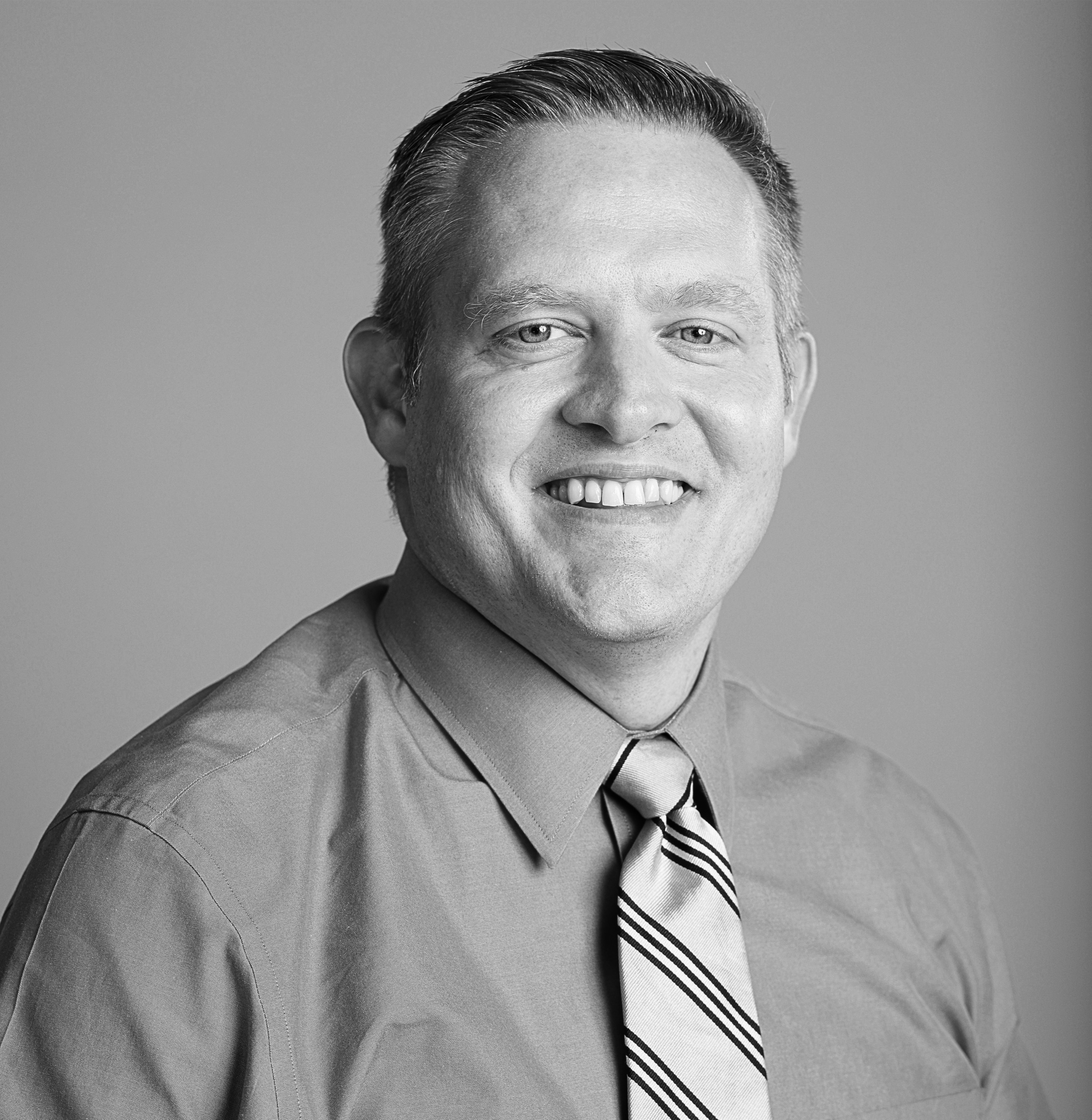 Dr. Brandon Bascom headshot in black and white.