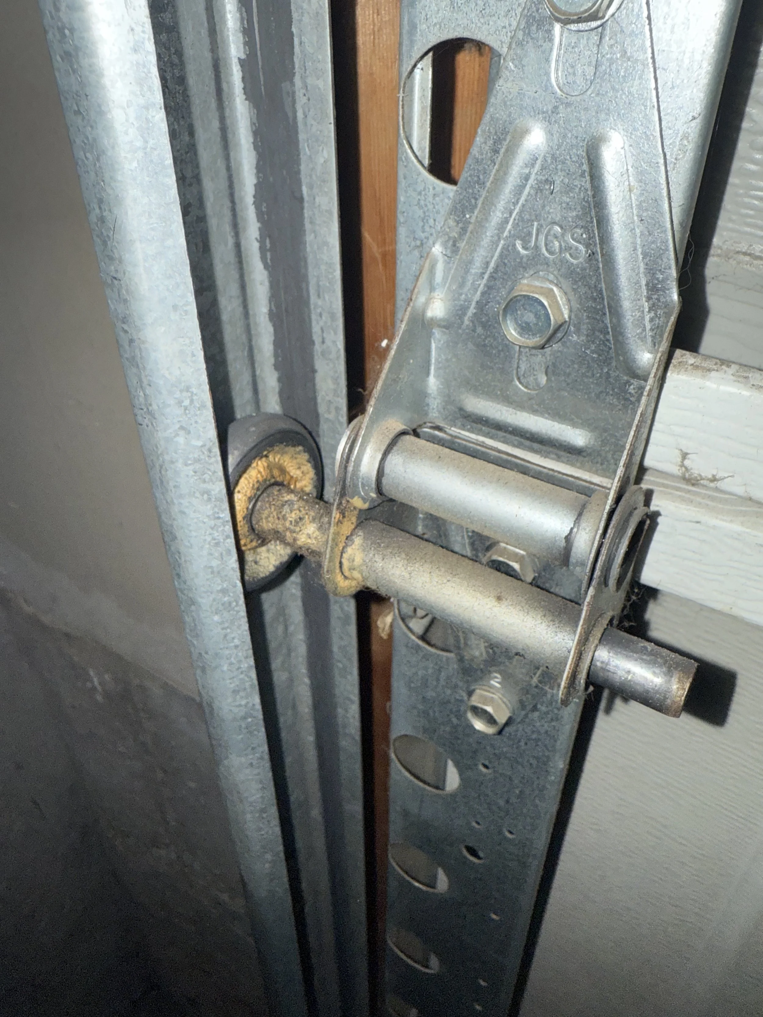 Garage door roller and hinge before repair in Roy Utah