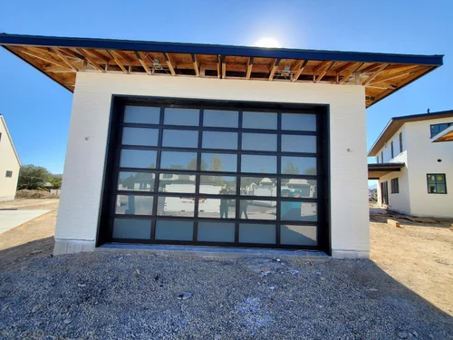 Garage door installation in Utah showing a modern glass garage door on a custom home