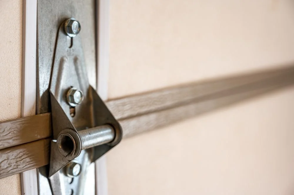 Garage door repair service showing garage door hinge