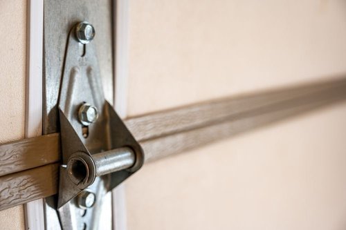 Garage door repair service showing garage door hinge