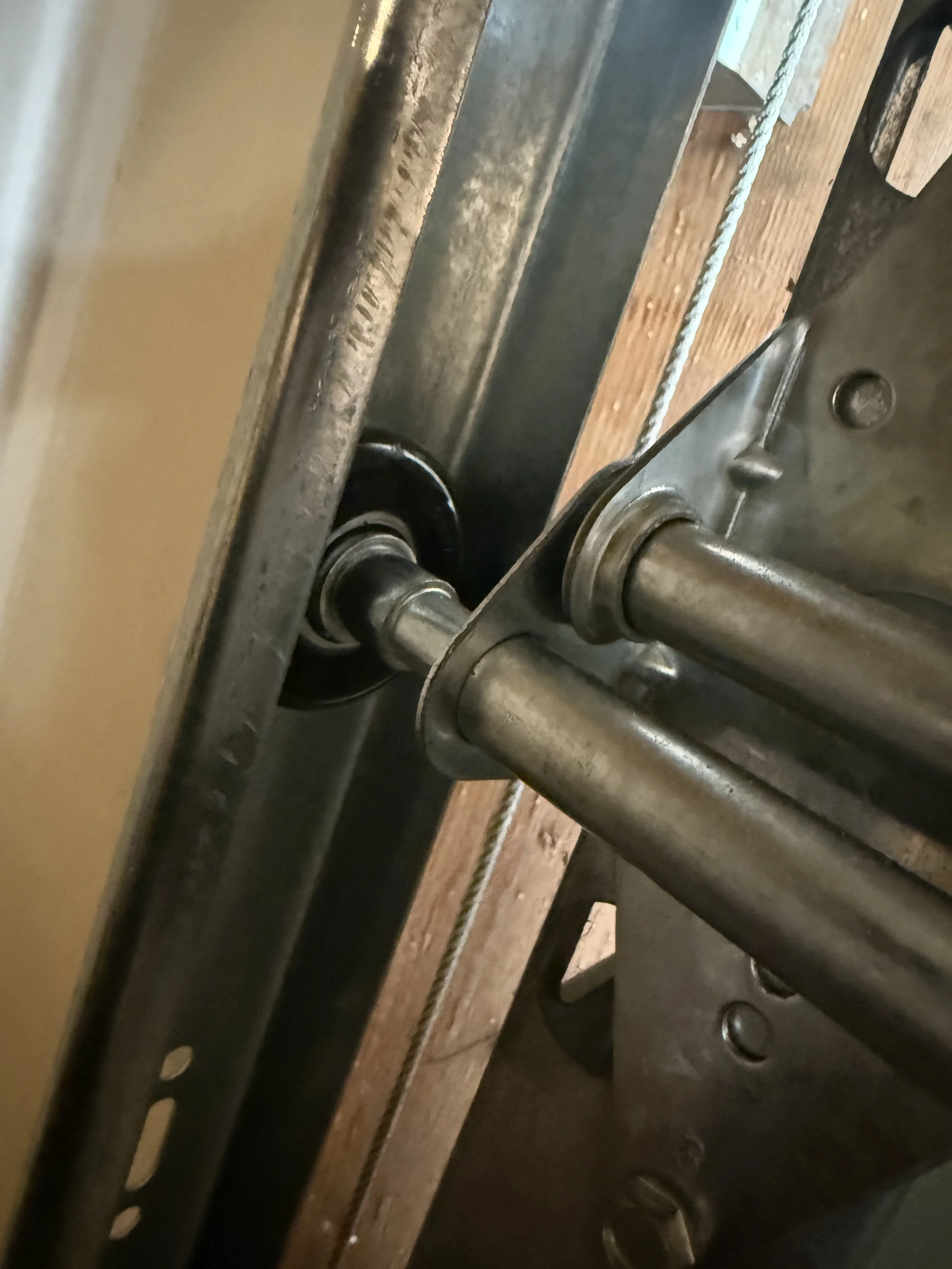 Garage door rollers and hardware being reset during off-track repair