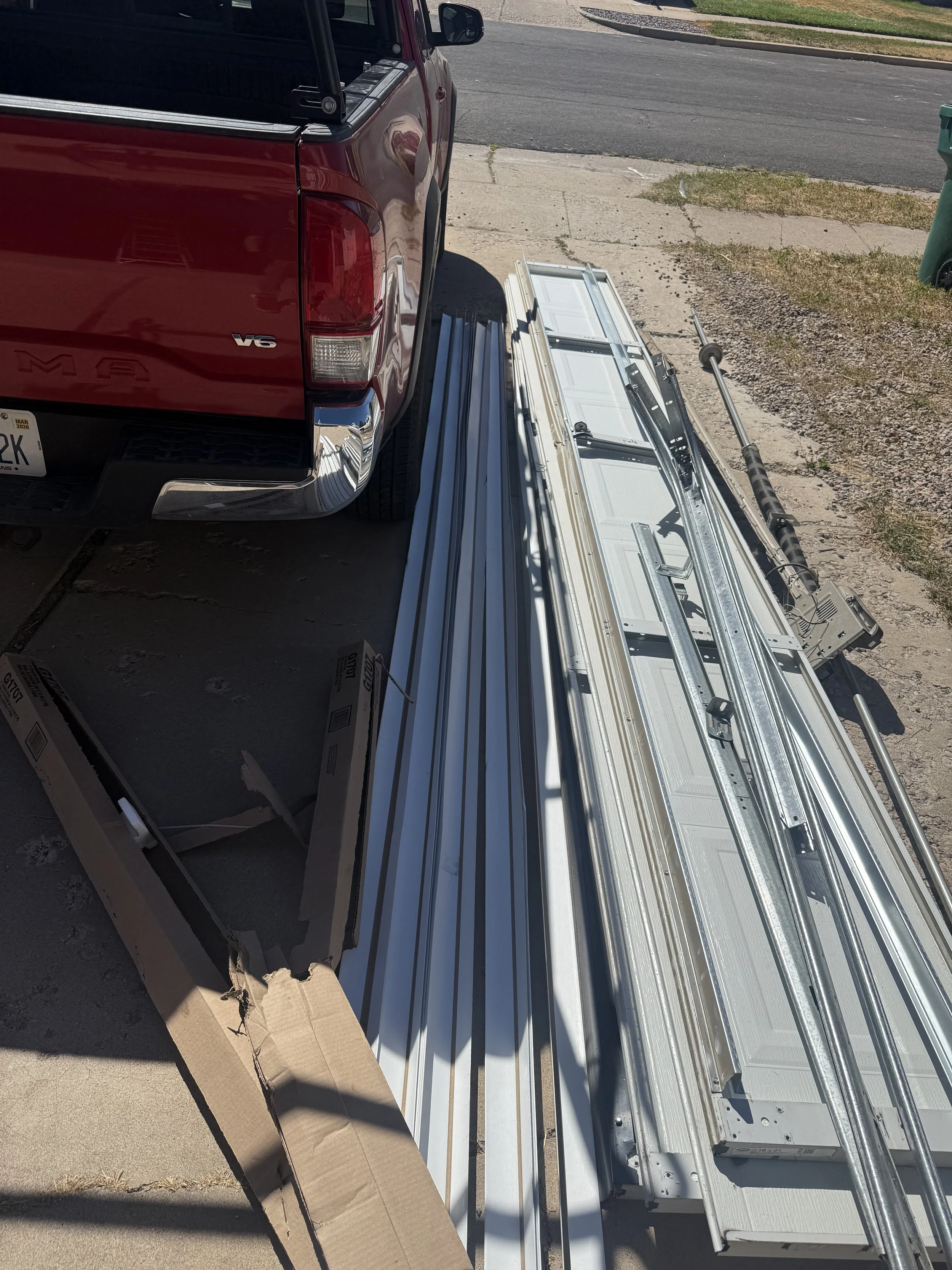 Old garage door removed and stacked before new garage door installation