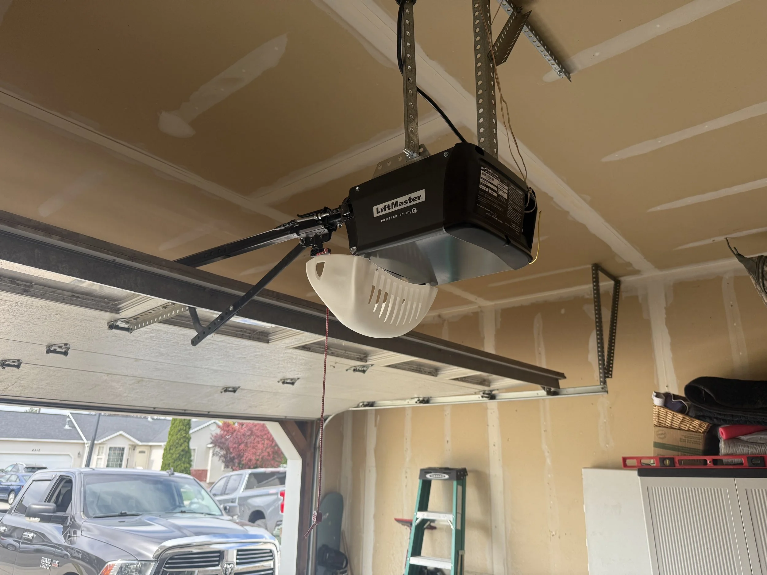 Garage door opener installation service showing a LiftMaster opener mounted in a garage