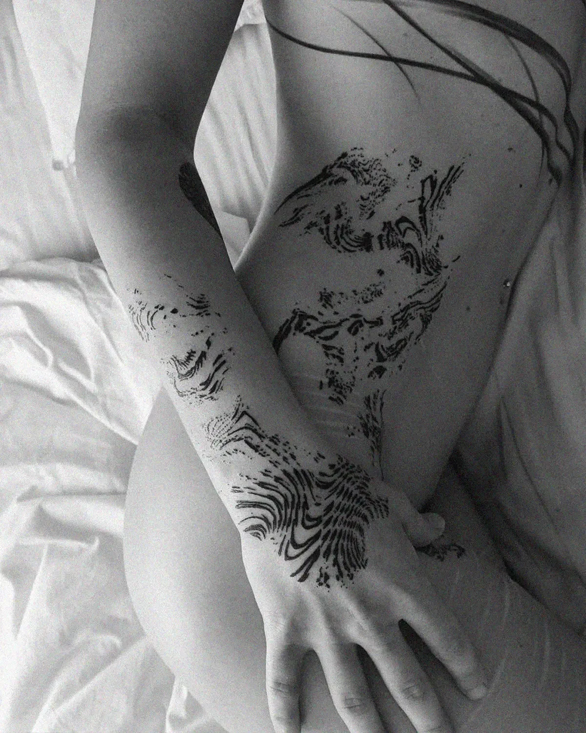 Abstract blackwork tattoo on waist and hip by ghost.of.catharsis. Kinetic ink flow study.