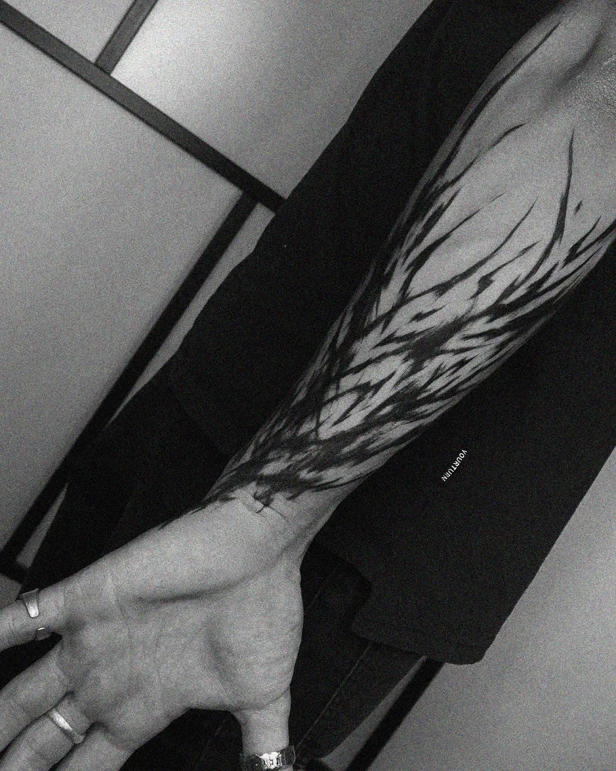 Kinetic blackwork tattoo on forearm. Flowing dark ink lines by ghost.of.catharsis.