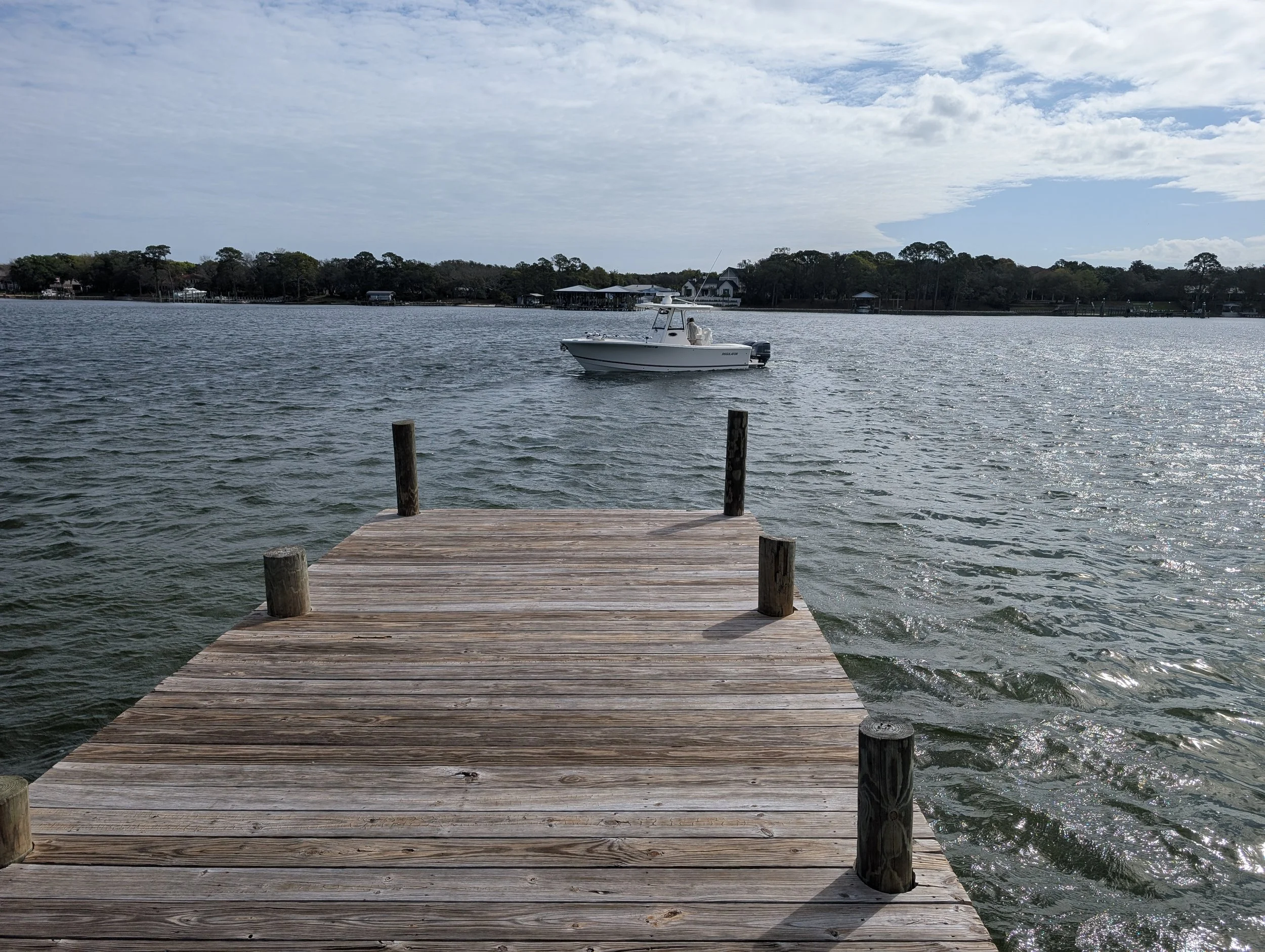 Boat driving lesson near dock at Destin Florida boat ramp