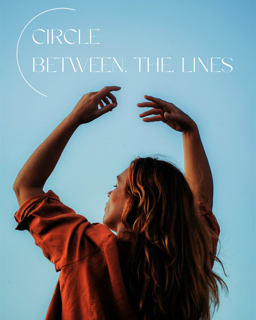A woman with long, wavy red hair in profile raising her arms with hands near her head against a clear blue sky, with the phrase 'Circle Between. The. Lines' written in white text.
