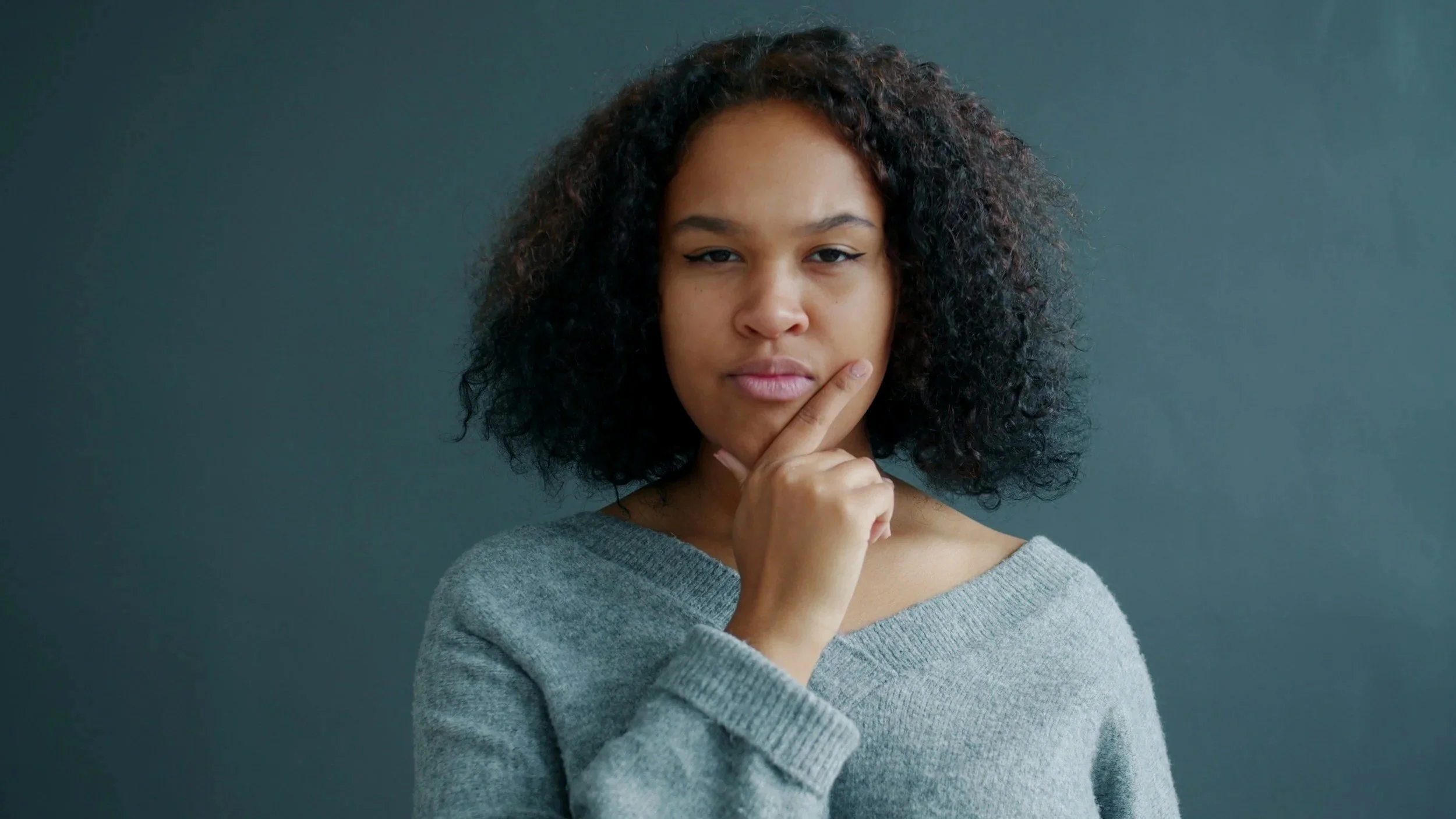 Woman reflecting on mental health and considering mental health therapy.