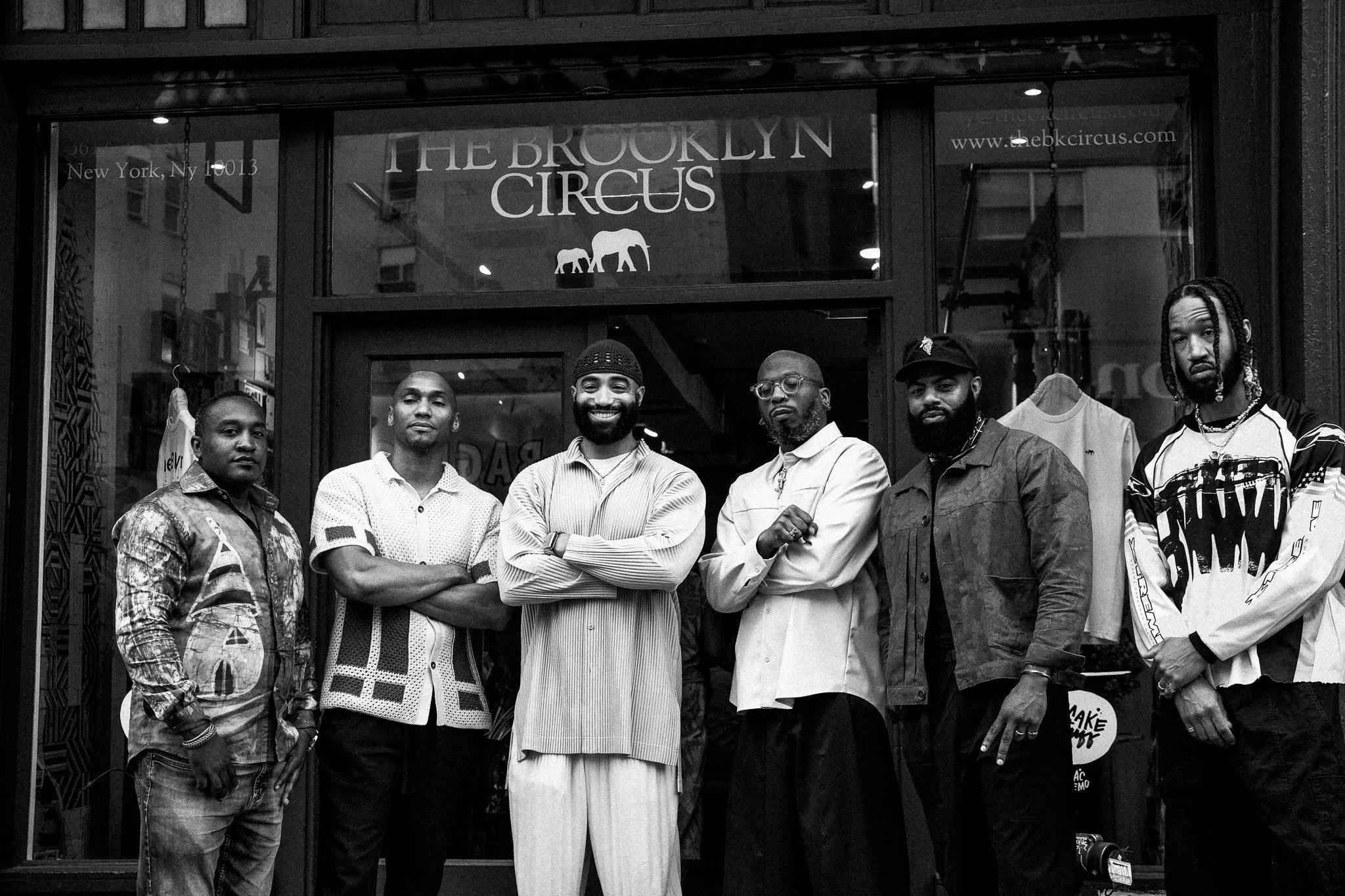 Group of seven men standing in front of The Brooklyn Circus store in New York City.