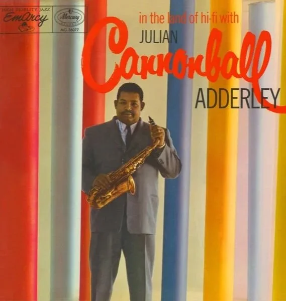 Album cover for “In the Land of Hi-Fi with Cannonball Adderley,” featuring Julian “Cannonball” Adderley holding a saxophone against colorful vertical stripes.