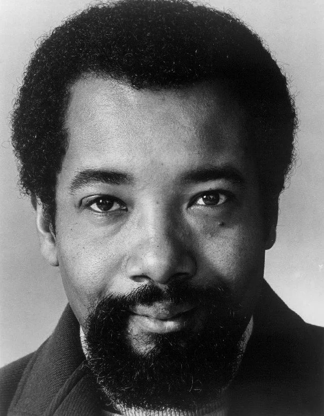 Black-and-white portrait of jazz trumpeter and composer Nat Adderley looking directly at the camera.