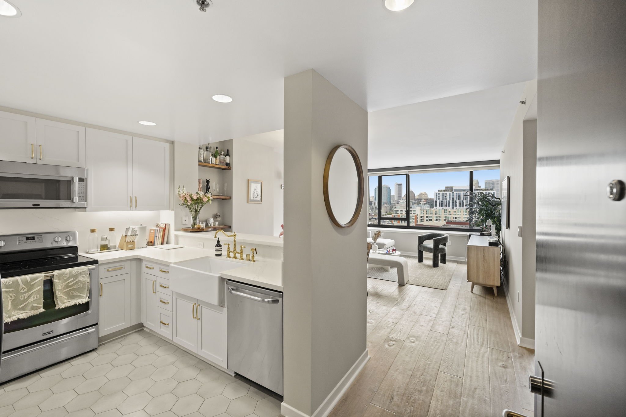 Open-concept kitchen and living room in a modern apartment with city view