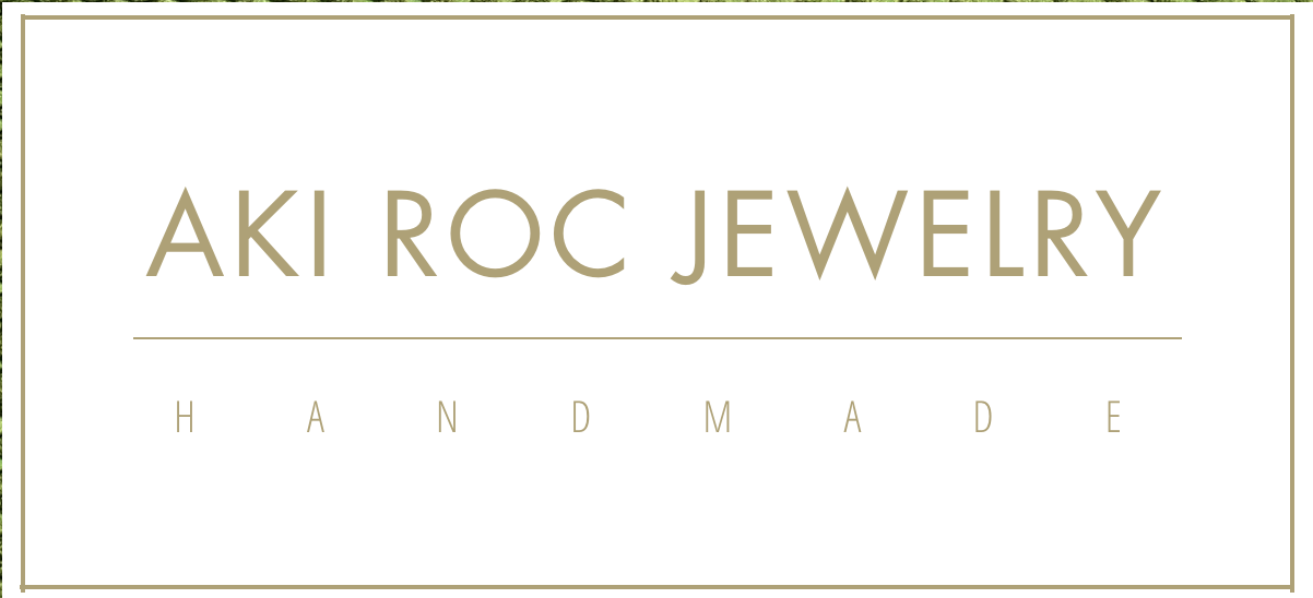 A promotional banner for Aki Roc Jewelry, featuring a white background with a gold border and gold text that reads "Aki Roc Jewelry" and "Handmade."