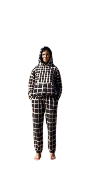 Person wearing a black and white checkered hoodie and matching pants, standing barefoot against black background.