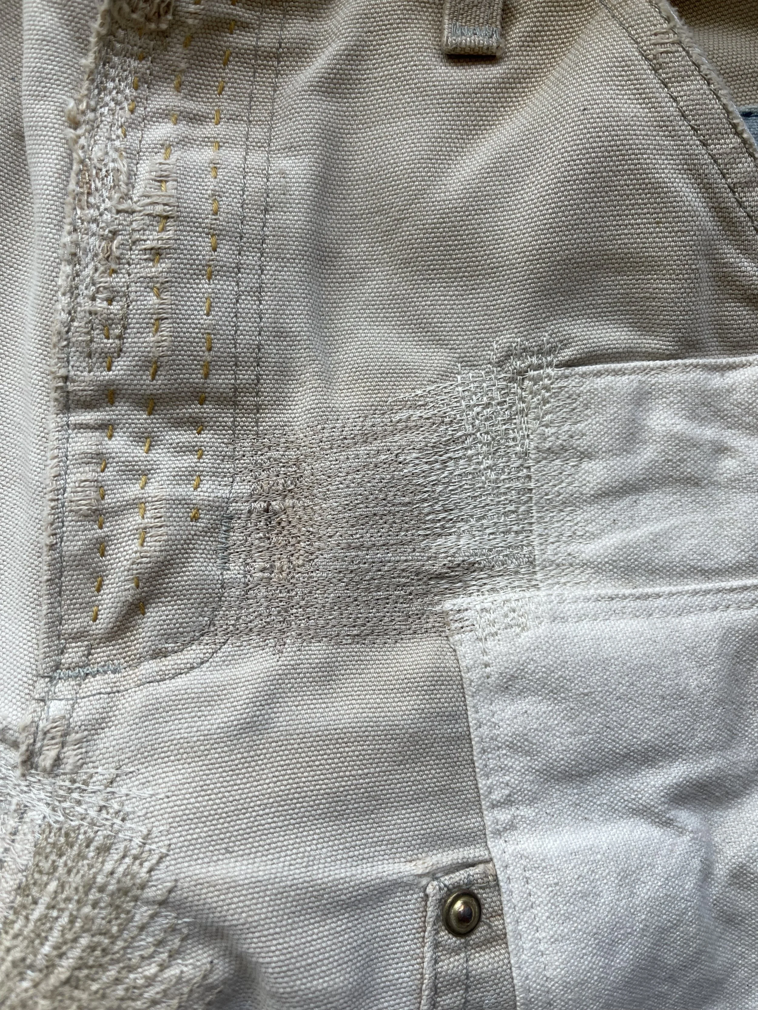 machine-darning and patchwork on very worn carhart work pants.