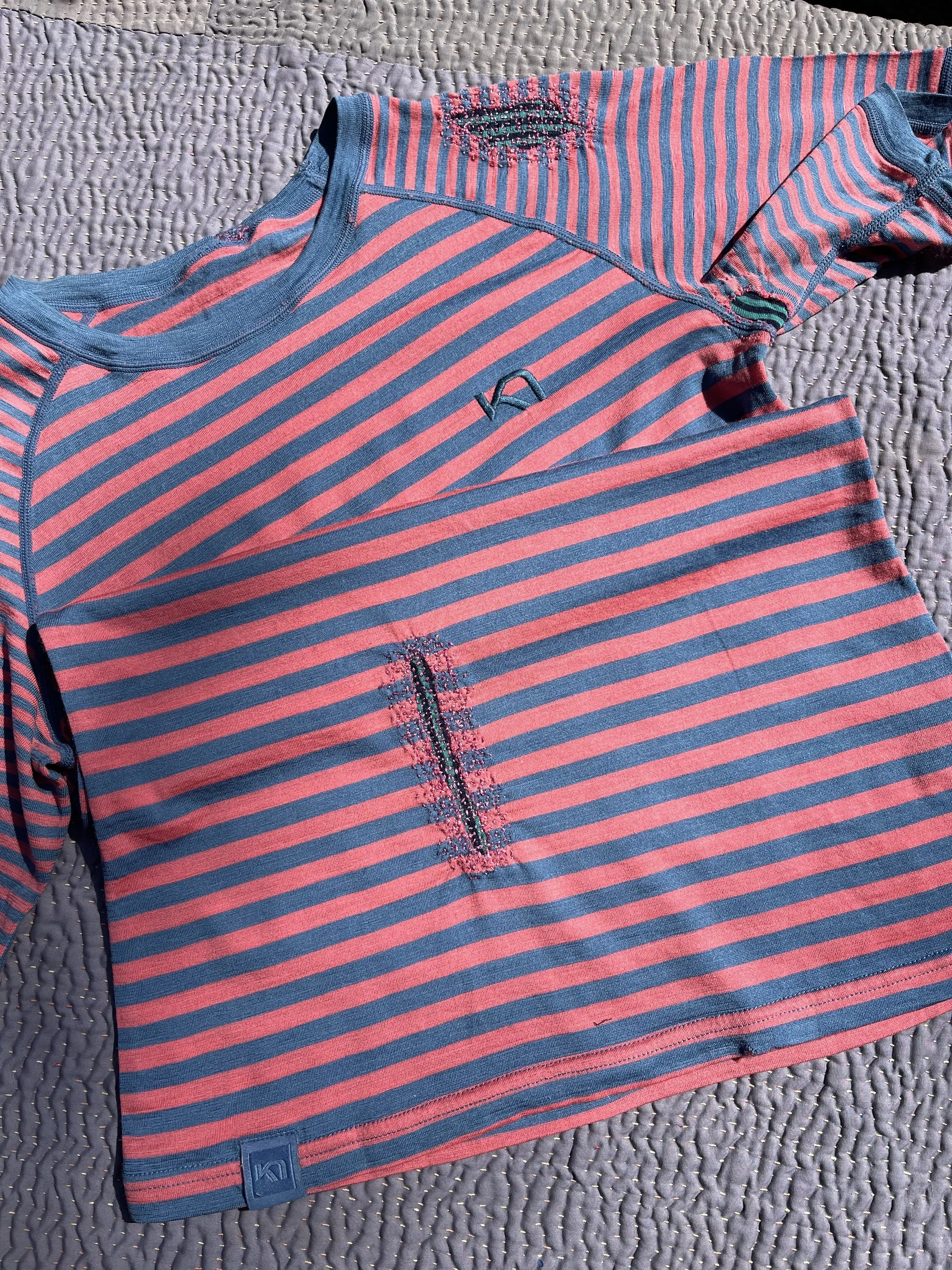 merino base layers are treated delicately with patches and hand darning.
