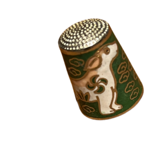 Decorative cylindrical object with a drawing of a bear and clouds, featuring a dotted pattern on top.