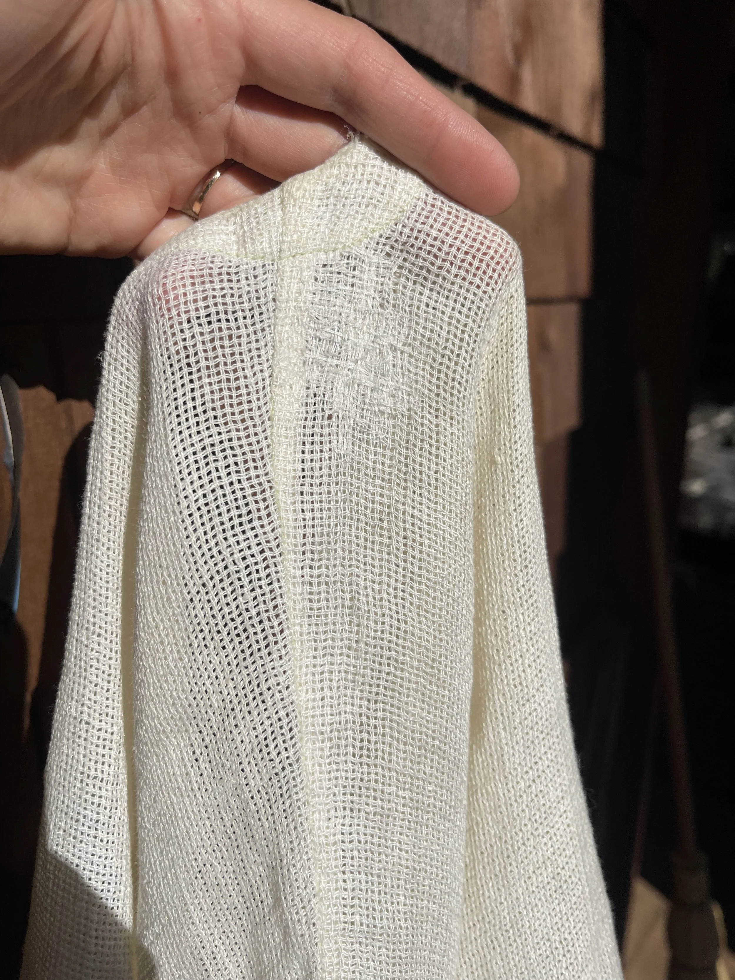 hand darning a loose-knit linen blouse