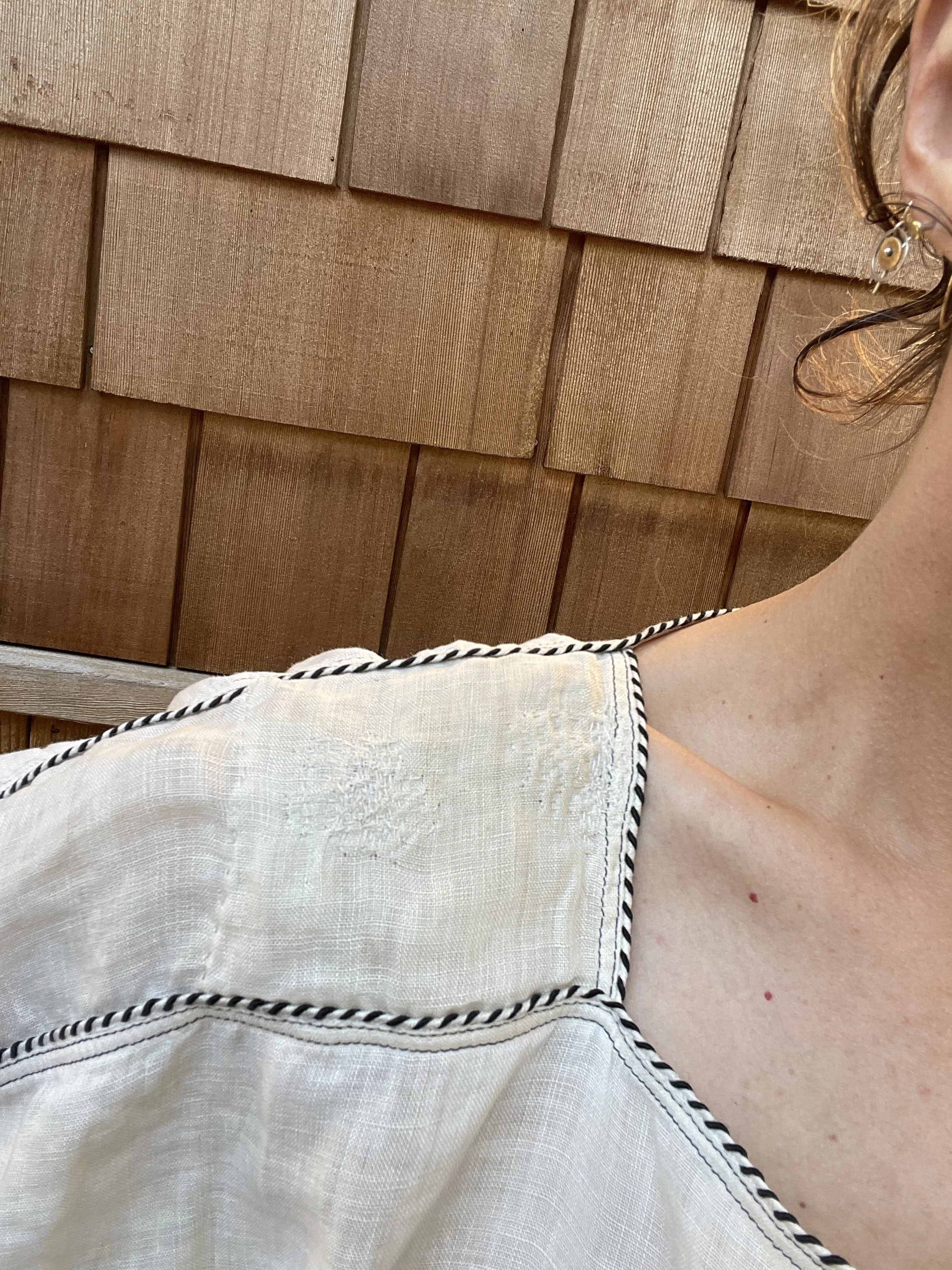 light linen blouse hand-darned and patched with cotton thread.