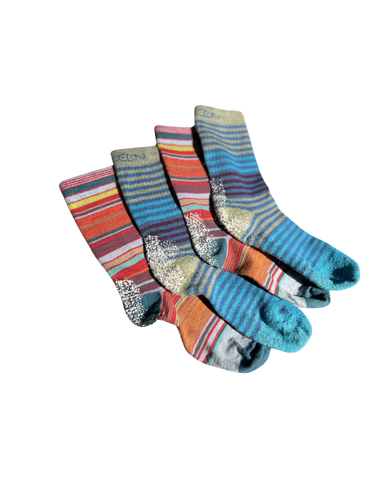 A pile of colorful striped socks arranged on a black background.