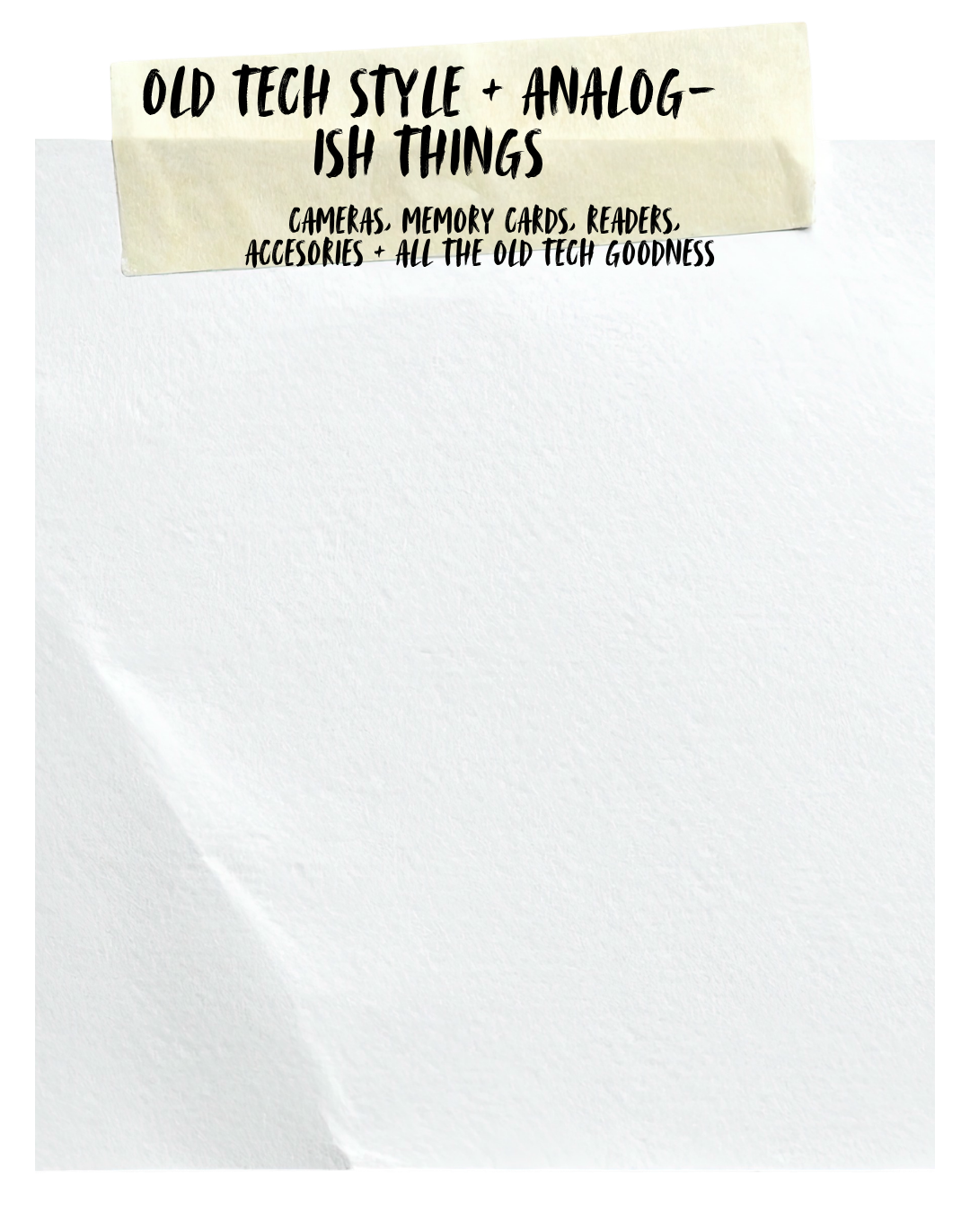 A piece of paper with a label reading 'Old Tech Style + Analog-ish Things' and listing 'Cameras, Memory Cards, Readers, Accessories + All the Old Tech Goodness' in black marker.