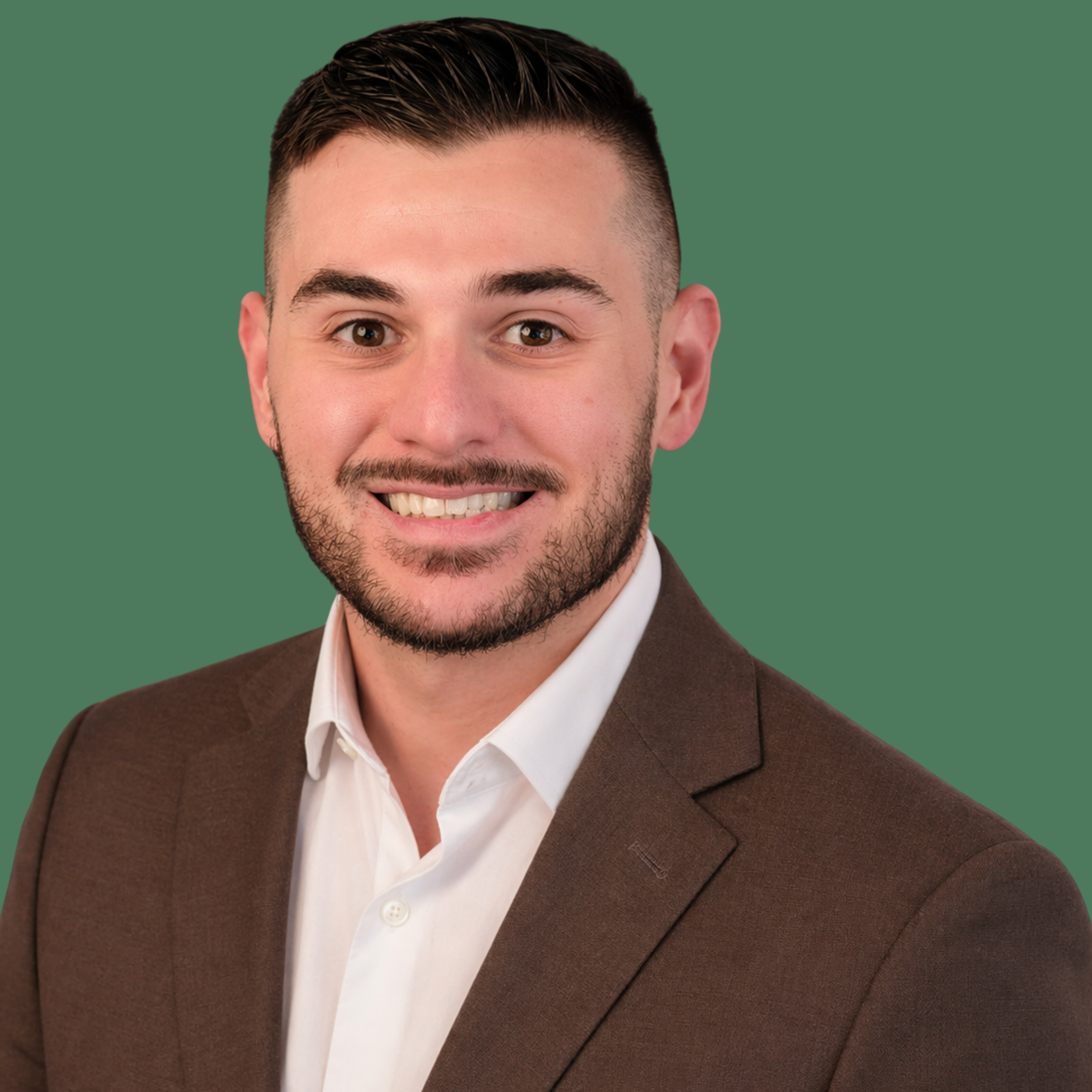 Headshot of smiling male consultant with short, dark hair wearing a brown suit and a white shirt.